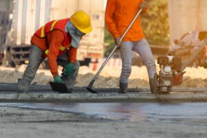 builders laying concrete